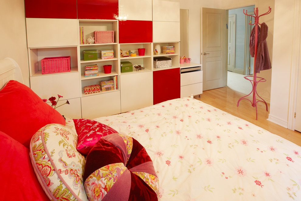 Design ideas for a mid-sized contemporary kids' room for girls in Toronto with white walls and light hardwood floors.