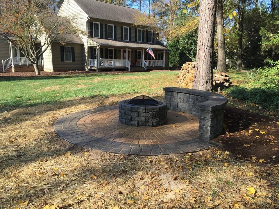 Photo of a large transitional backyard partial sun garden for fall in Richmond with a fire feature and natural stone pavers.