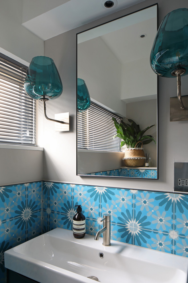 Design ideas for a small contemporary bathroom in London with blue cabinets, blue tile, cement tile and a single vanity.