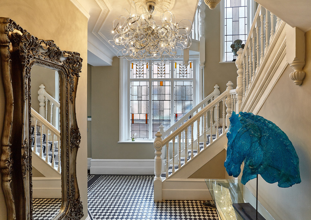 This is an example of an eclectic hallway in London with beige walls and multi-coloured floor.