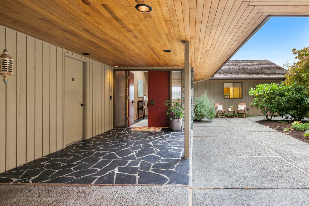 This is an example of an expansive midcentury front door in Seattle with a single front door and a red front door.