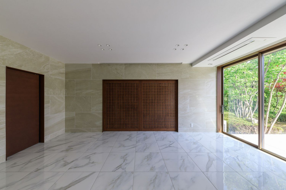 Inspiration for a large asian enclosed ceramic tile, white floor, wallpaper ceiling and wall paneling living room remodel in Osaka with a music area, beige walls and a wall-mounted tv