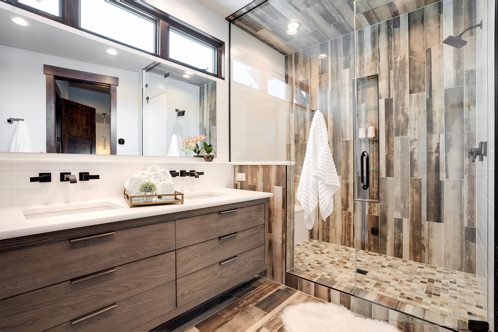Photo of a contemporary 3/4 bathroom in Denver with flat-panel cabinets, medium wood cabinets, an alcove shower, white walls, an undermount sink, brown floor, a hinged shower door and white benchtops.