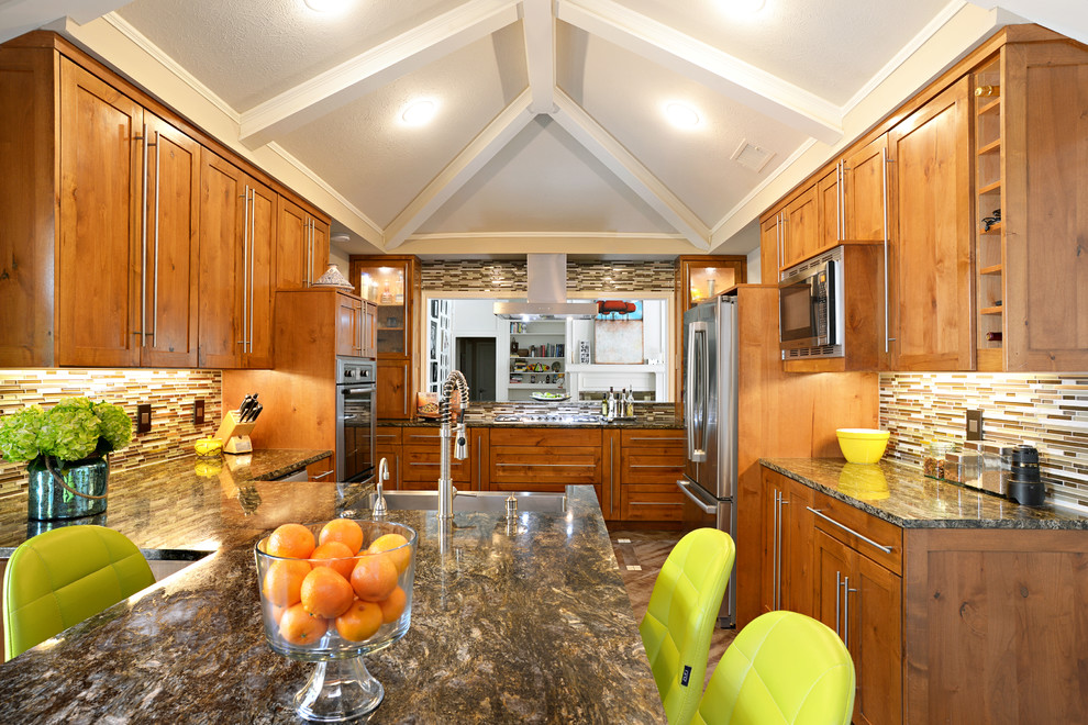 Eat-in kitchen - large transitional u-shaped travertine floor eat-in kitchen idea in Dallas with a farmhouse sink, medium tone wood cabinets, granite countertops, multicolored backsplash, matchstick tile backsplash, stainless steel appliances and a peninsula