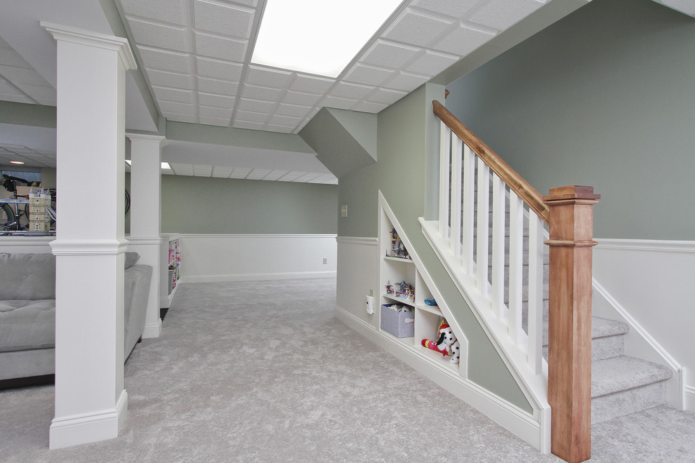 Photo of a large transitional basement in Philadelphia with green walls and carpet.