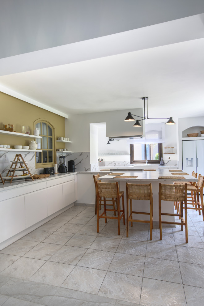 This is an example of a large mediterranean open plan kitchen in Montpellier with with island.