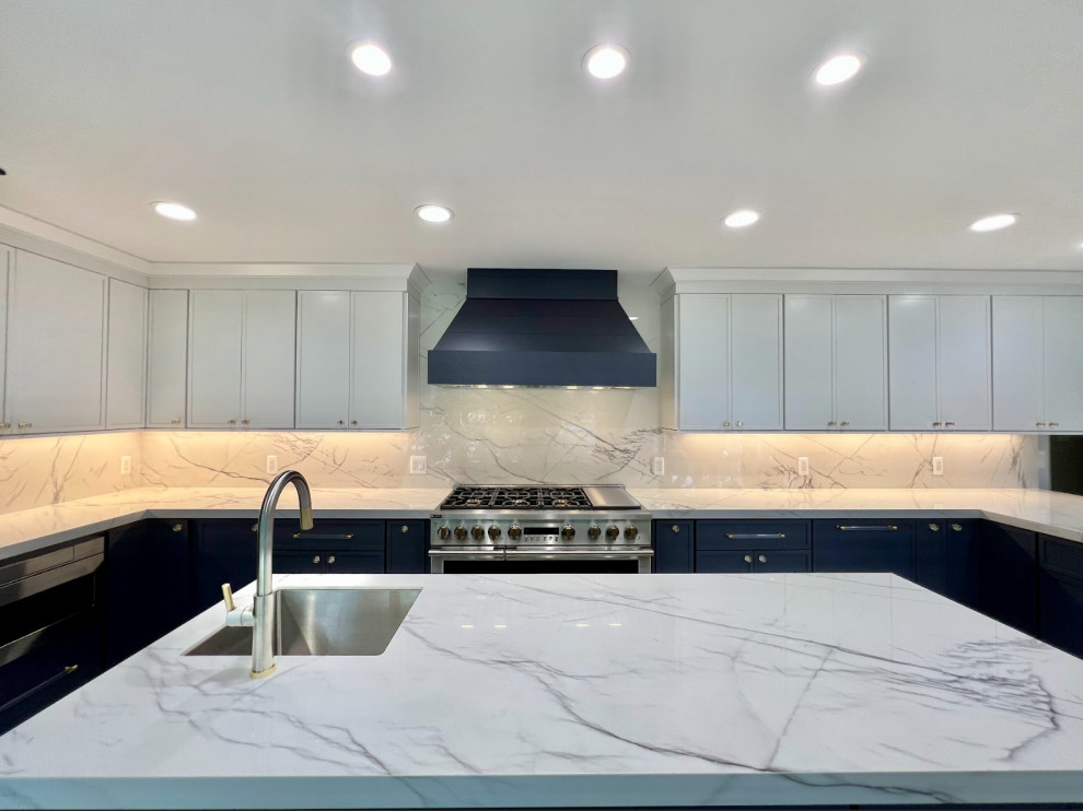 This is an example of an expansive contemporary single-wall separate kitchen in Detroit with an undermount sink, flat-panel cabinets, white cabinets, granite benchtops, white splashback, granite splashback, panelled appliances, porcelain floors, with island, blue floor and white benchtop.