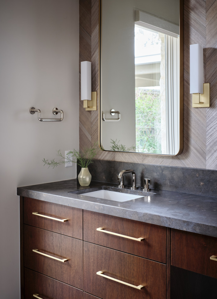 Inspiration for a midcentury bathroom in Austin with flat-panel cabinets, brown cabinets, an undermount tub, a corner shower, white tile, porcelain tile, white walls, porcelain floors, an undermount sink, limestone benchtops, grey floor, a hinged shower door, grey benchtops, a double vanity, a built-in vanity and wallpaper.