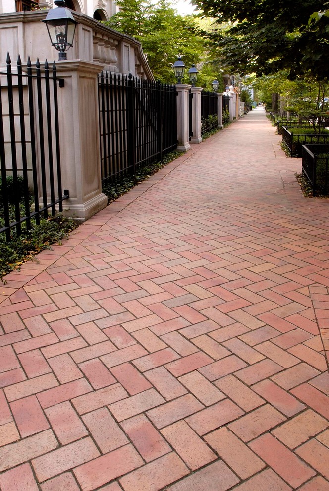 Inspiration for an expansive traditional front yard patio in Chicago with brick pavers and no cover.