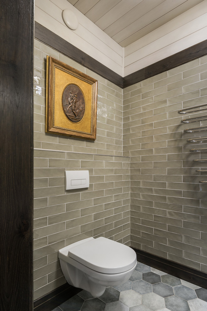 Photo of a small traditional bathroom in Moscow with raised-panel cabinets, beige cabinets, a wall-mount toilet, green tile, ceramic tile, green walls, ceramic floors, a drop-in sink, grey floor, a hinged shower door, an enclosed toilet, a single vanity, a floating vanity, timber and planked wall panelling.