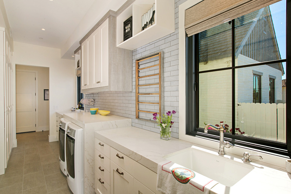 Country single-wall dedicated laundry room in San Diego with an undermount sink, shaker cabinets, white cabinets, white walls, a side-by-side washer and dryer, grey floor and white benchtop.
