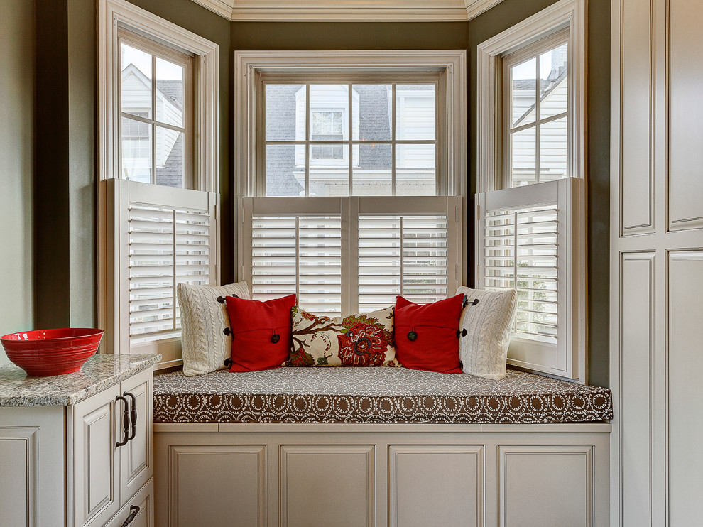 Example of a mountain style enclosed kitchen design in Columbus with a farmhouse sink, flat-panel cabinets, white cabinets, marble countertops, beige backsplash, stone tile backsplash and stainless steel appliances