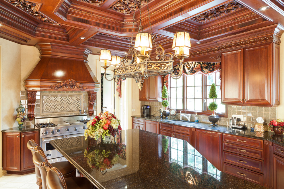 Photo of a large traditional u-shaped eat-in kitchen in New York with an undermount sink, raised-panel cabinets, brown cabinets, granite benchtops, stainless steel appliances, ceramic floors and with island.