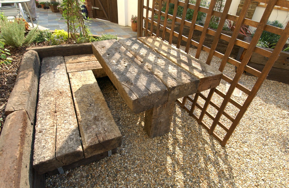 Photo of a medium sized mediterranean back patio in London with a vegetable patch and gravel.