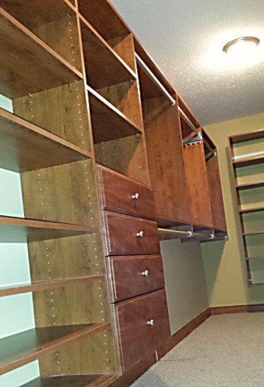 Photo of a contemporary storage and wardrobe in Columbus with open cabinets and medium wood cabinets.