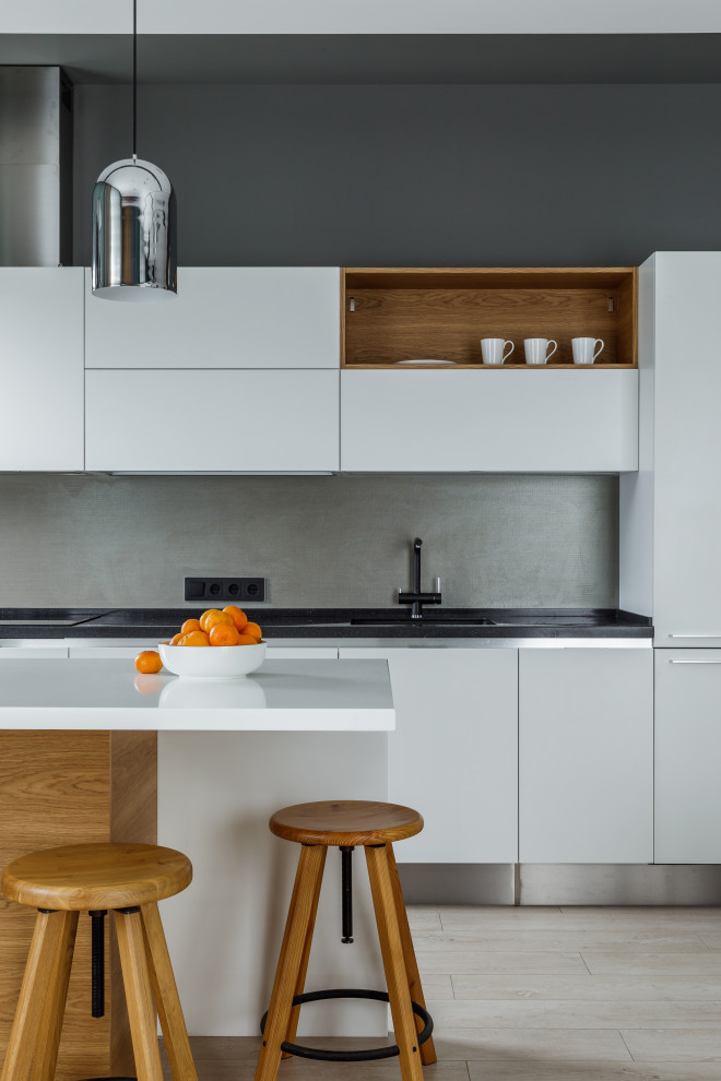 Photo of a contemporary kitchen in Other with flat-panel cabinets and white cabinets.