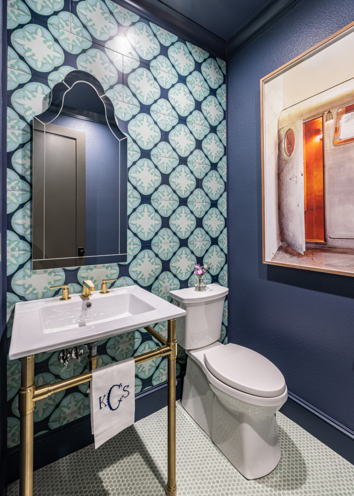 Design ideas for a small traditional cloakroom in Dallas with a one-piece toilet, multi-coloured tiles, blue walls, porcelain flooring, a console sink, green floors, a freestanding vanity unit, white cabinets, solid surface worktops, white worktops and wood walls.