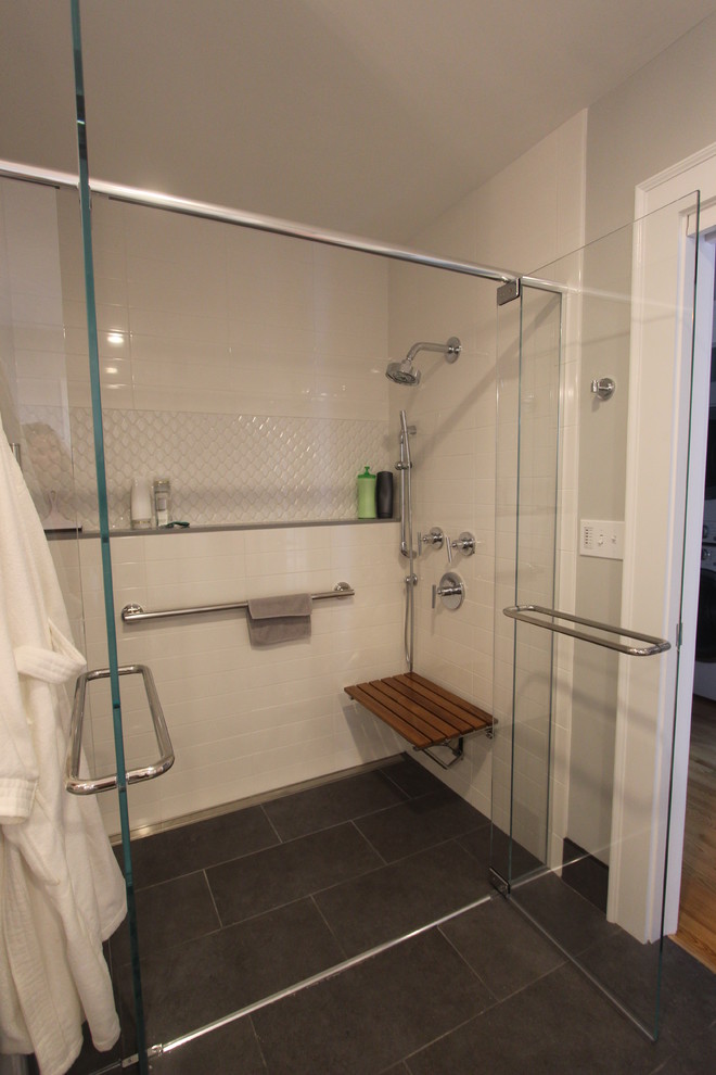 Design ideas for a mid-sized modern bathroom in Boston with flat-panel cabinets, white cabinets, a curbless shower, a two-piece toilet, white tile, ceramic tile, grey walls, porcelain floors, an undermount sink, engineered quartz benchtops, grey floor and a hinged shower door.