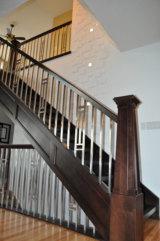Mid-sized modern wood u-shaped staircase in Calgary with open risers.