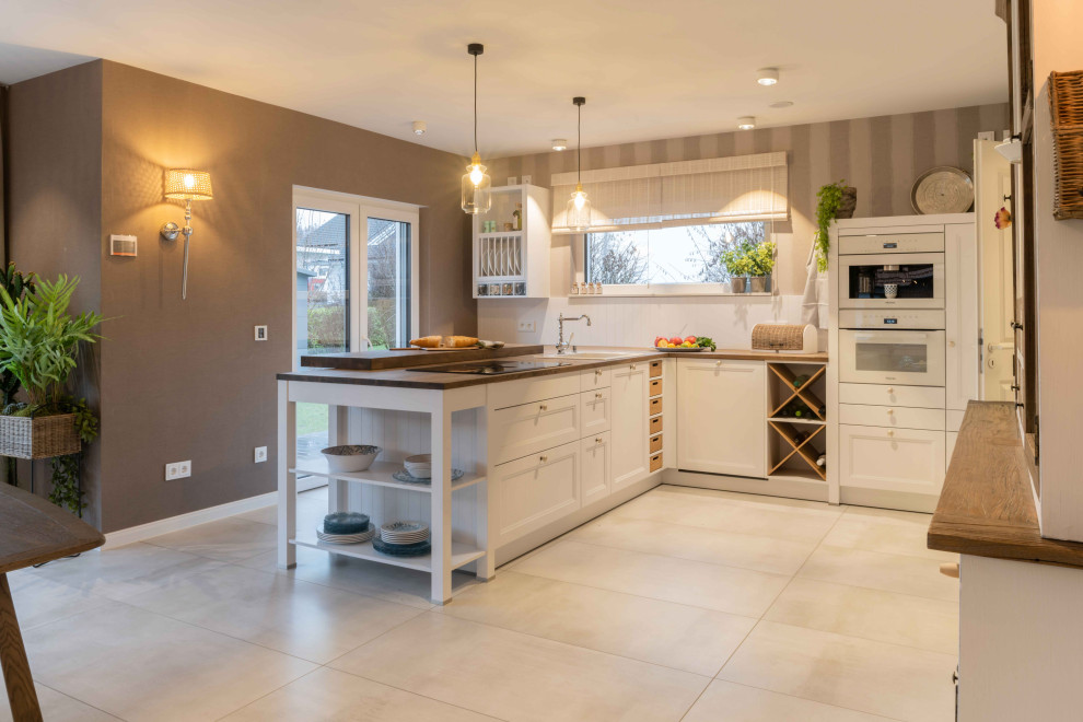 Photo of an expansive modern l-shaped open plan kitchen in Other with a built-in sink, wood worktops, white splashback, terracotta flooring, a breakfast bar, beige floors and brown worktops.