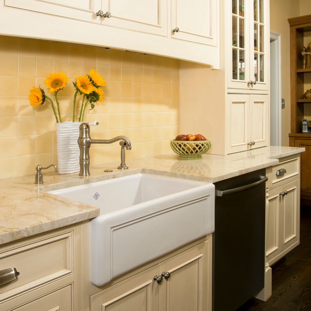 This is an example of a traditional galley kitchen in DC Metro with a farmhouse sink, recessed-panel cabinets, white cabinets, quartzite benchtops, yellow splashback, stainless steel appliances, dark hardwood floors and no island.