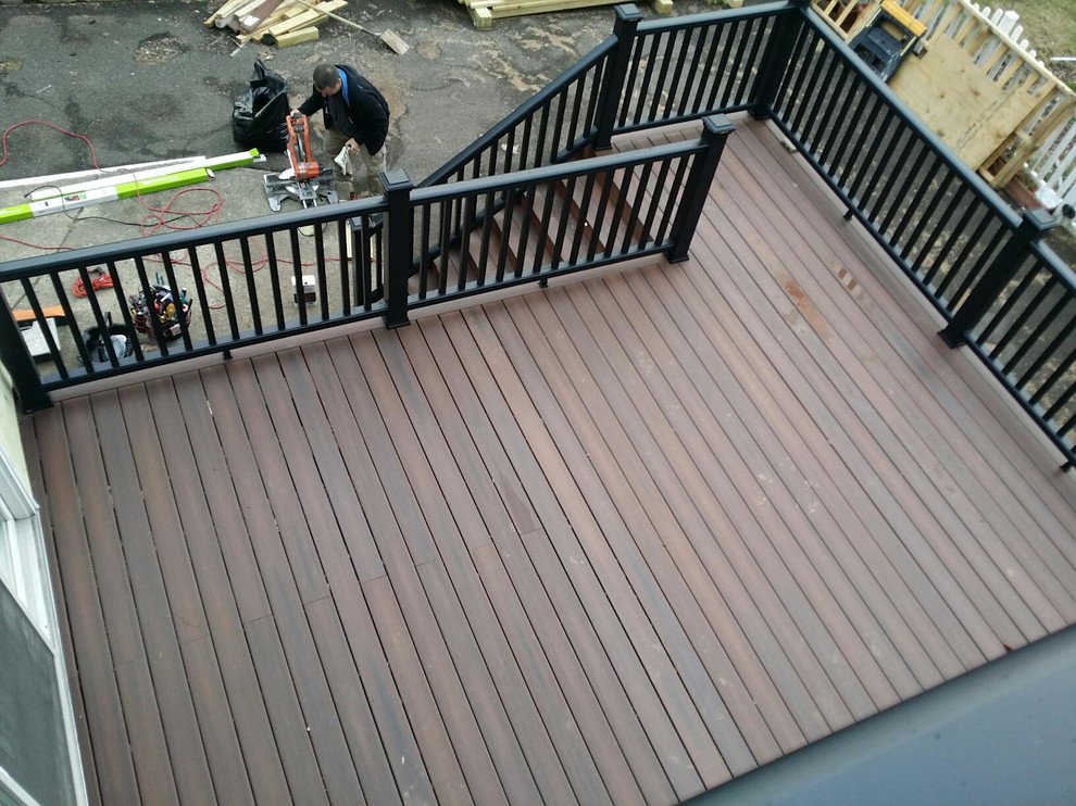 Deck - huge rustic backyard balcony deck idea in New York with a roof extension