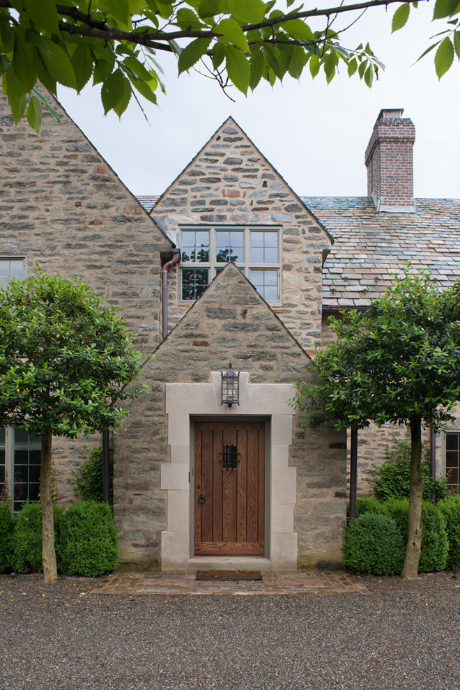 This is an example of a traditional entryway in Philadelphia with a single front door and a medium wood front door.
