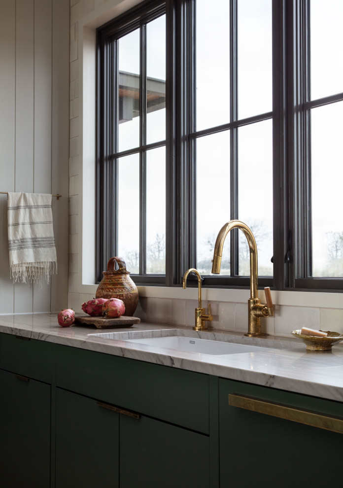 Martindale Water Ski Retreat - Inspiration for a mid-sized contemporary galley kitchen remodel in Austin with an undermount sink, flat-panel cabinets, green cabinets, quartzite countertops, white backsplash, terra-cotta backsplash, stainless steel appliances, a peninsula and beige countertops