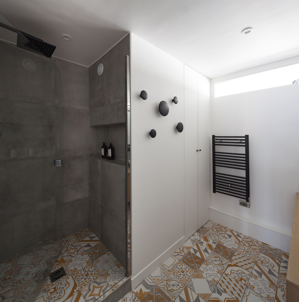 Inspiration for a mid-sized scandinavian master bathroom in Paris with white cabinets, an alcove shower, gray tile, terra-cotta tile, white walls, ceramic floors, a vessel sink, wood benchtops, yellow floor and a hinged shower door.