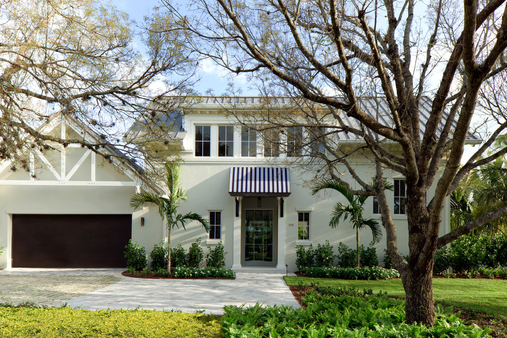 Inspiration for a mid-sized transitional two-storey white exterior in Miami with a gable roof.