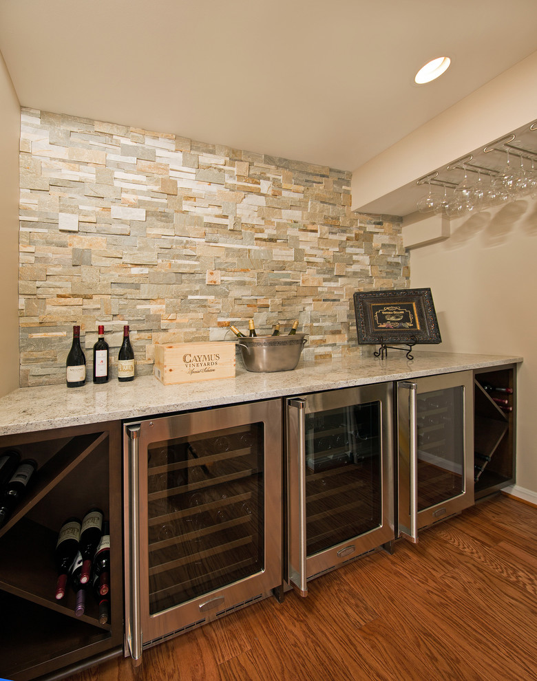 Design ideas for a mid-sized transitional wine cellar in DC Metro with medium hardwood floors and diamond bins.