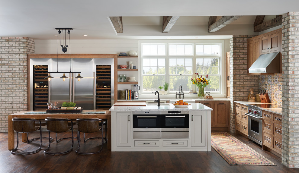 Mid-sized transitional l-shaped dark wood floor kitchen photo in New York with recessed-panel cabinets, light wood cabinets, multicolored backsplash, mosaic tile backsplash, stainless steel appliances and an island