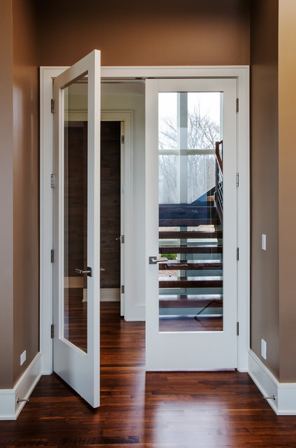 Den With Walnut Floor And Glass Panel French Door With View