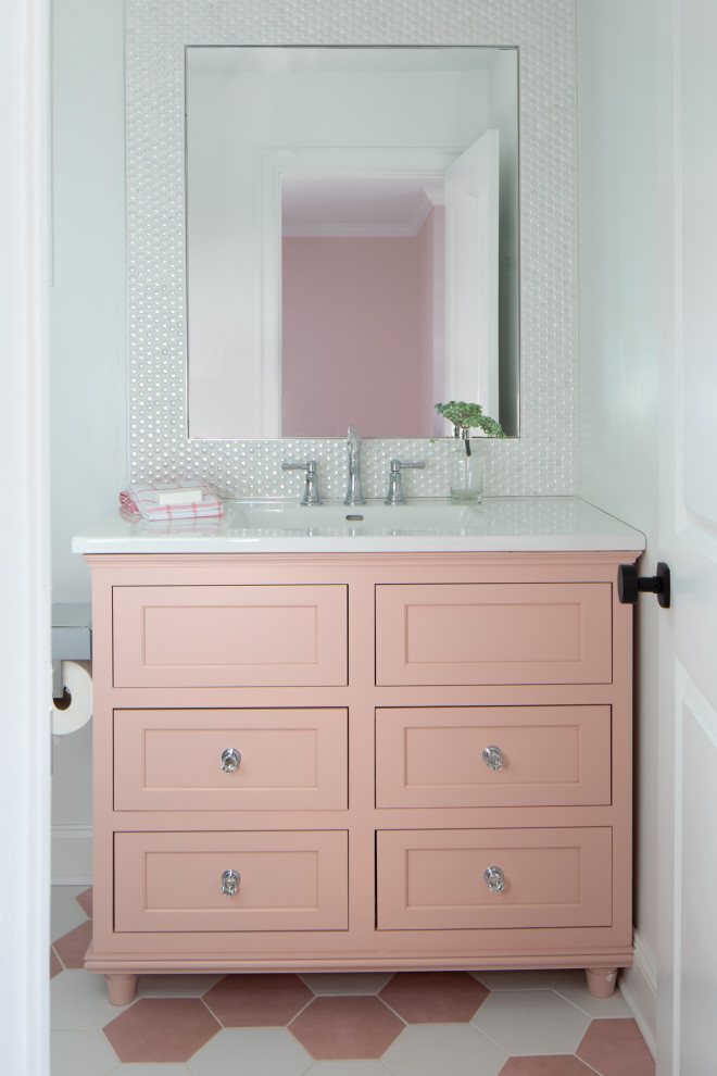 Medium sized contemporary family bathroom in Newark with shaker cabinets, an alcove shower, a one-piece toilet, white tiles, porcelain tiles, white walls, porcelain flooring, an integrated sink, solid surface worktops, pink floors, a sliding door, white worktops, a single sink and a freestanding vanity unit.