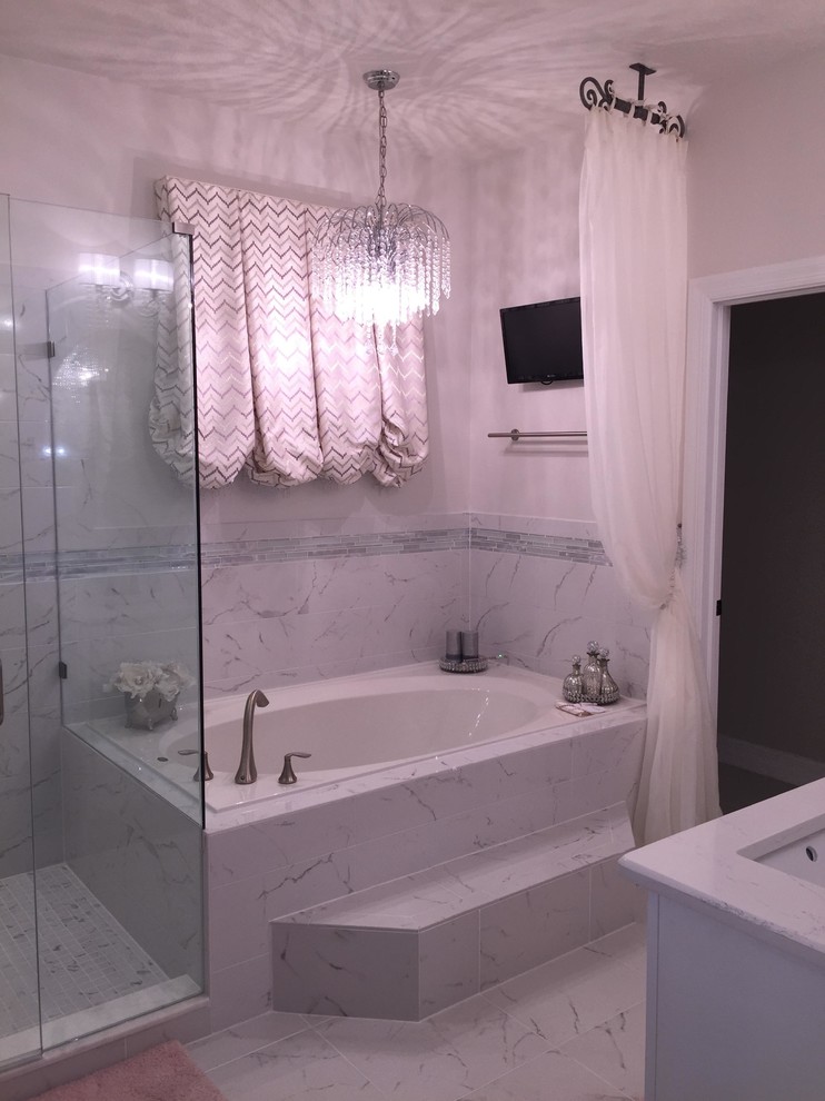 Mid-sized contemporary master bathroom in Orlando with recessed-panel cabinets, white cabinets, a drop-in tub, an alcove shower, a one-piece toilet, white walls, marble floors, an undermount sink and marble benchtops.