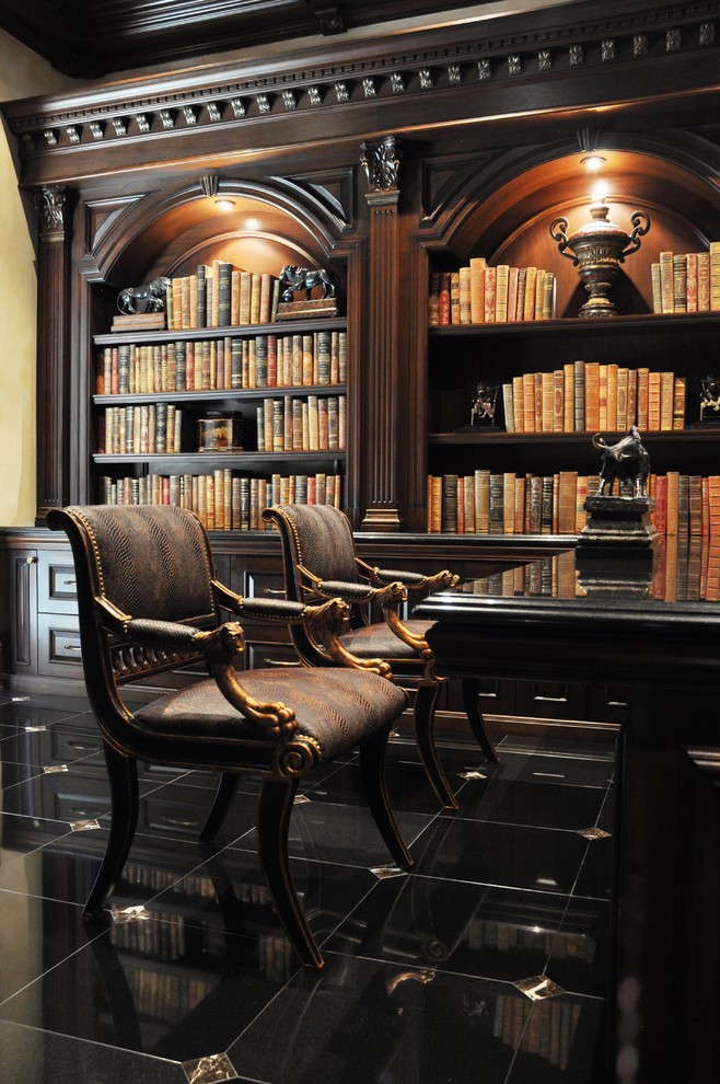 Large traditional home office in New York with a library, beige walls, porcelain floors, a freestanding desk and black floor.