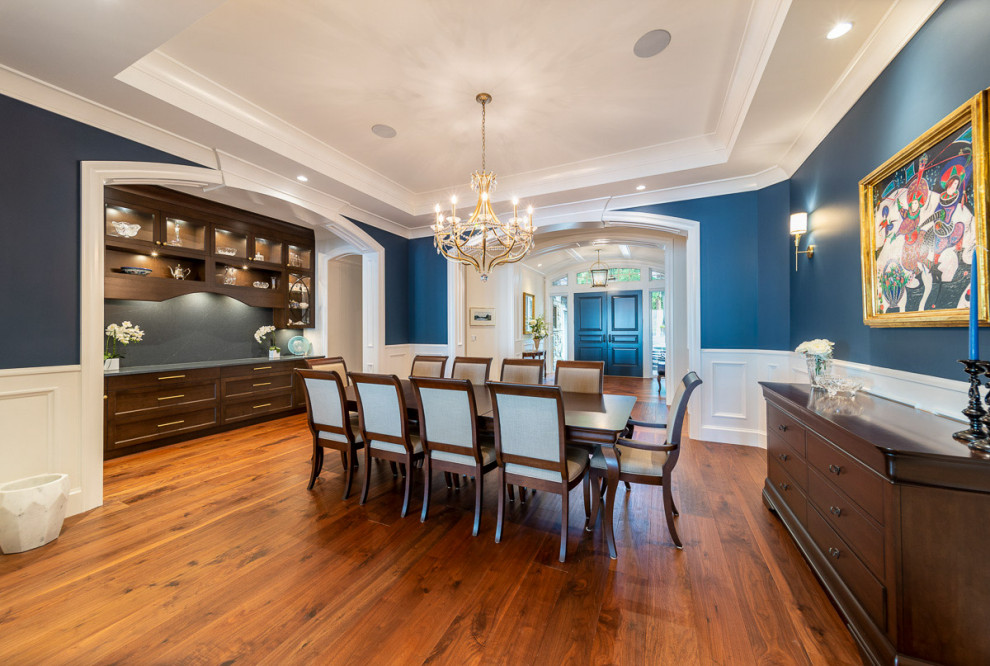 Inspiration for a mid-sized transitional separate dining room in Vancouver with blue walls, medium hardwood floors and brown floor.
