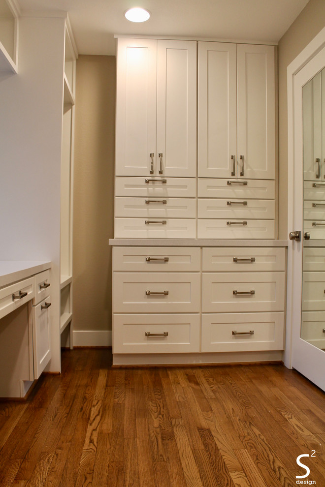 Design ideas for a large midcentury gender-neutral dressing room in Houston with shaker cabinets, white cabinets, medium hardwood floors and brown floor.
