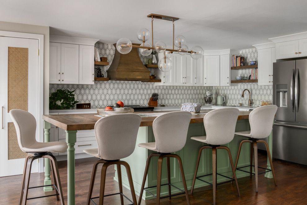Example of a mid-sized transitional laminate floor and brown floor kitchen design in Philadelphia with an undermount sink, quartz countertops, multicolored backsplash, marble backsplash, stainless steel appliances, an island and gray countertops