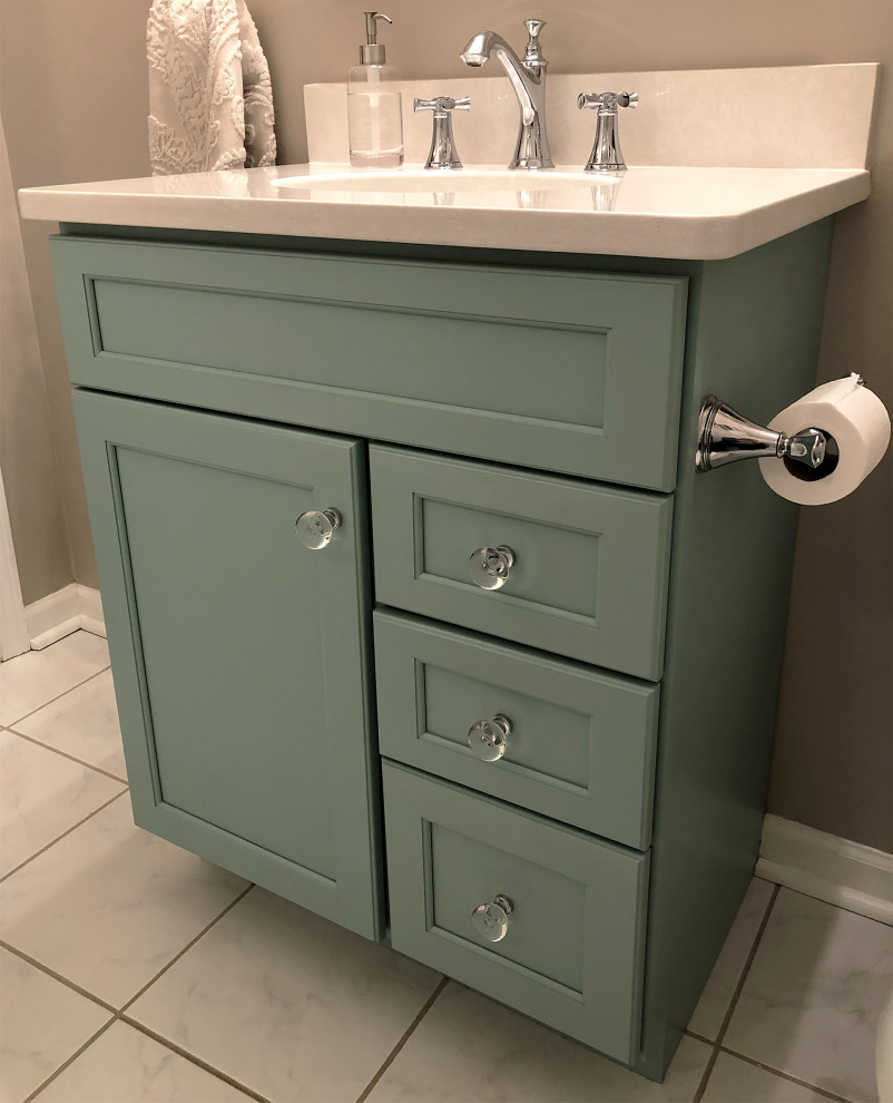 Small bathroom in St Louis with recessed-panel cabinets, turquoise cabinets, an alcove tub, white tile, ceramic tile, ceramic floors, an undermount sink, engineered quartz benchtops, a hinged shower door and white benchtops.