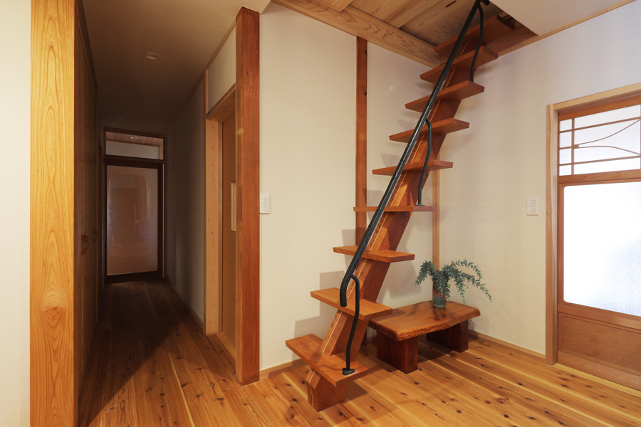 Photo of a mid-sized asian wood straight staircase in Other with wood risers and metal railing.