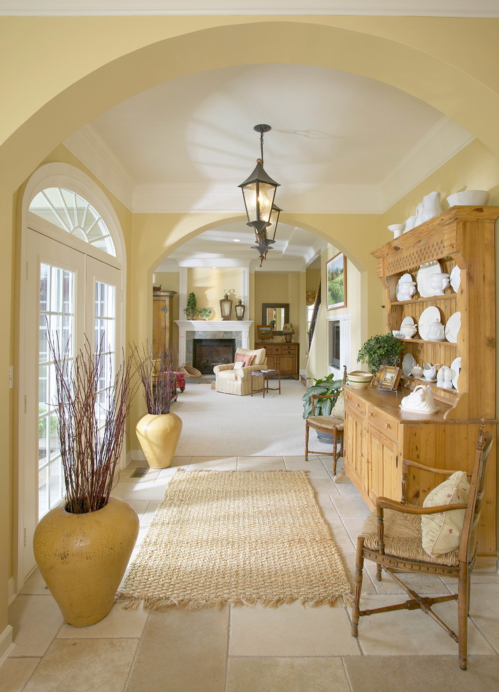 Inspiration for a large traditional hallway in DC Metro with yellow walls and travertine floors.