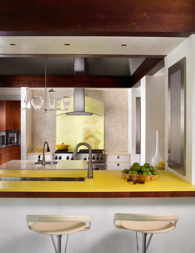 This is an example of a contemporary separate kitchen in Nashville with an undermount sink, flat-panel cabinets, yellow splashback, stone slab splashback, stainless steel appliances and yellow benchtop.