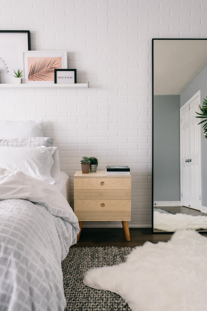 Medium sized scandinavian master bedroom in Toronto with white walls, dark hardwood flooring and brown floors.