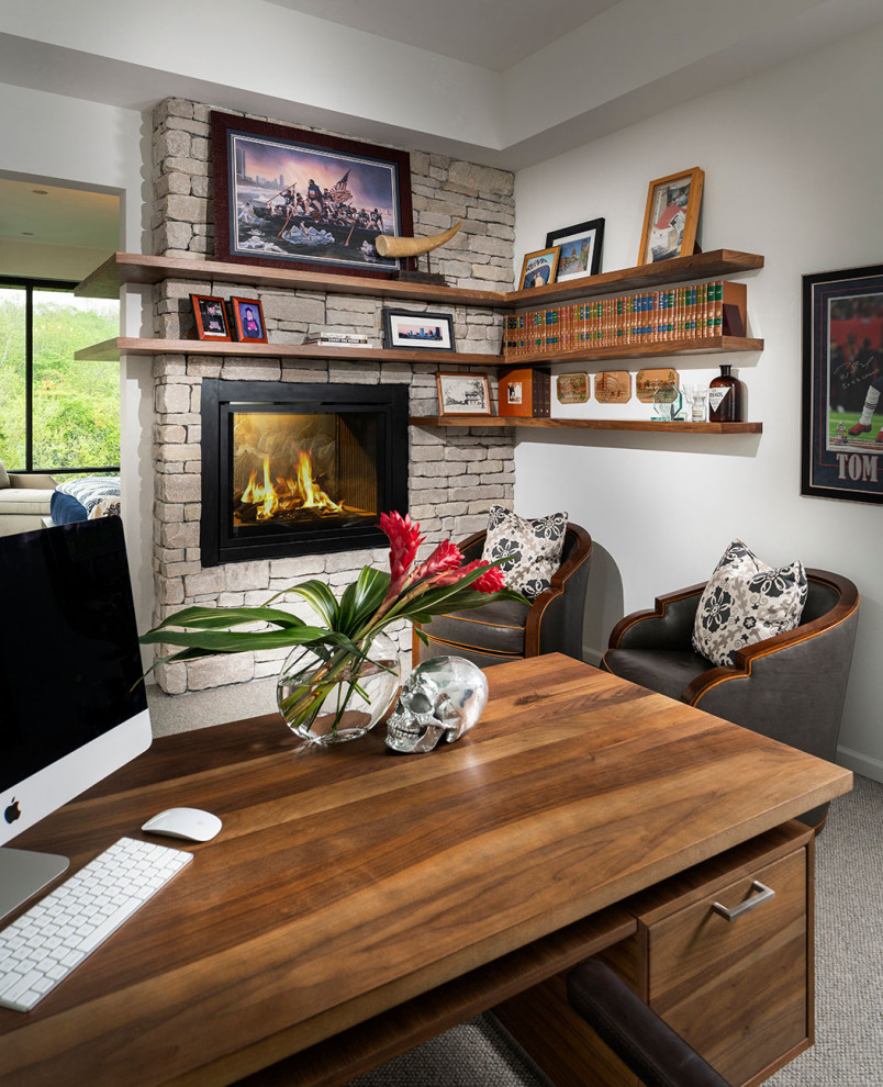 Ejemplo de despacho moderno de tamaño medio con moqueta, chimenea de doble cara, piedra de revestimiento y bandeja