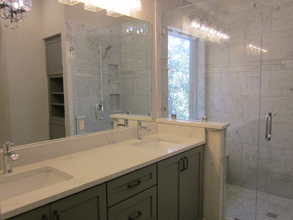 Mediterranean bathroom in Austin with marble floors and a double vanity.