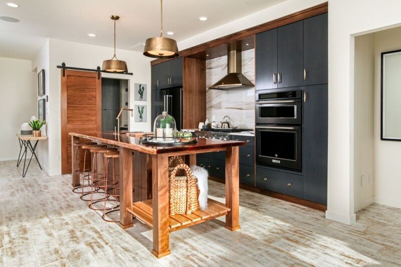Inspiration for a large contemporary single-wall eat-in kitchen in Calgary with an undermount sink, flat-panel cabinets, blue cabinets, wood benchtops, white splashback, porcelain splashback, stainless steel appliances, laminate floors and with island.