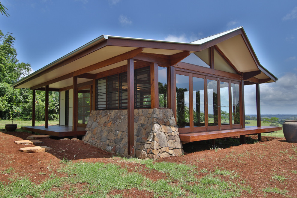 Photo of a tropical home design in Brisbane.