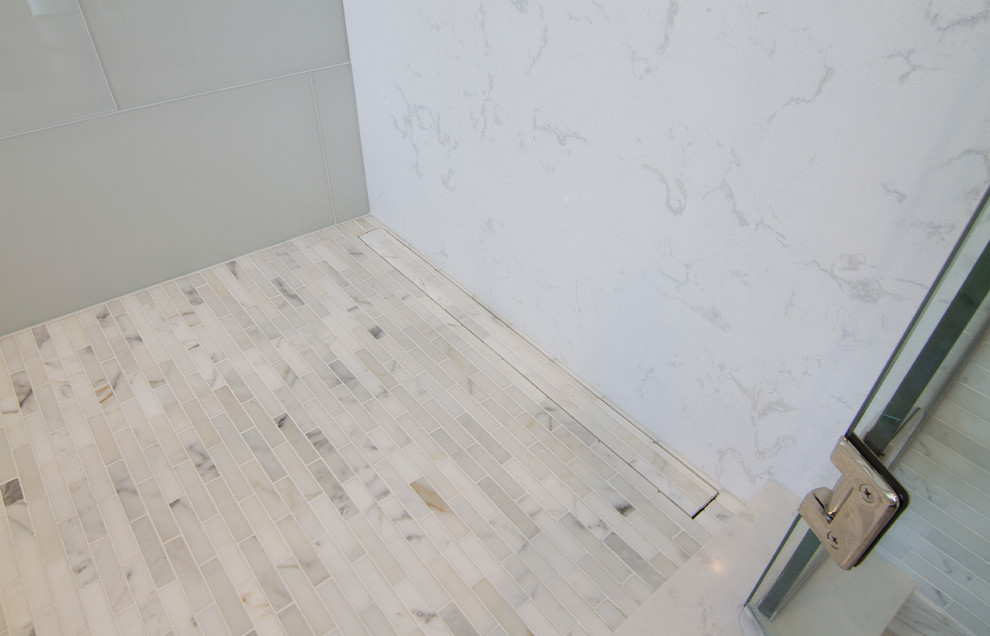 Example of a mid-sized transitional master gray tile porcelain tile home design design in Minneapolis with furniture-like cabinets, gray cabinets, an undermount tub, a bidet, gray walls, an undermount sink and quartzite countertops