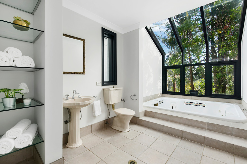 Mid-sized transitional master bathroom in Sydney with a drop-in tub, a one-piece toilet, white walls, ceramic floors and beige floor.